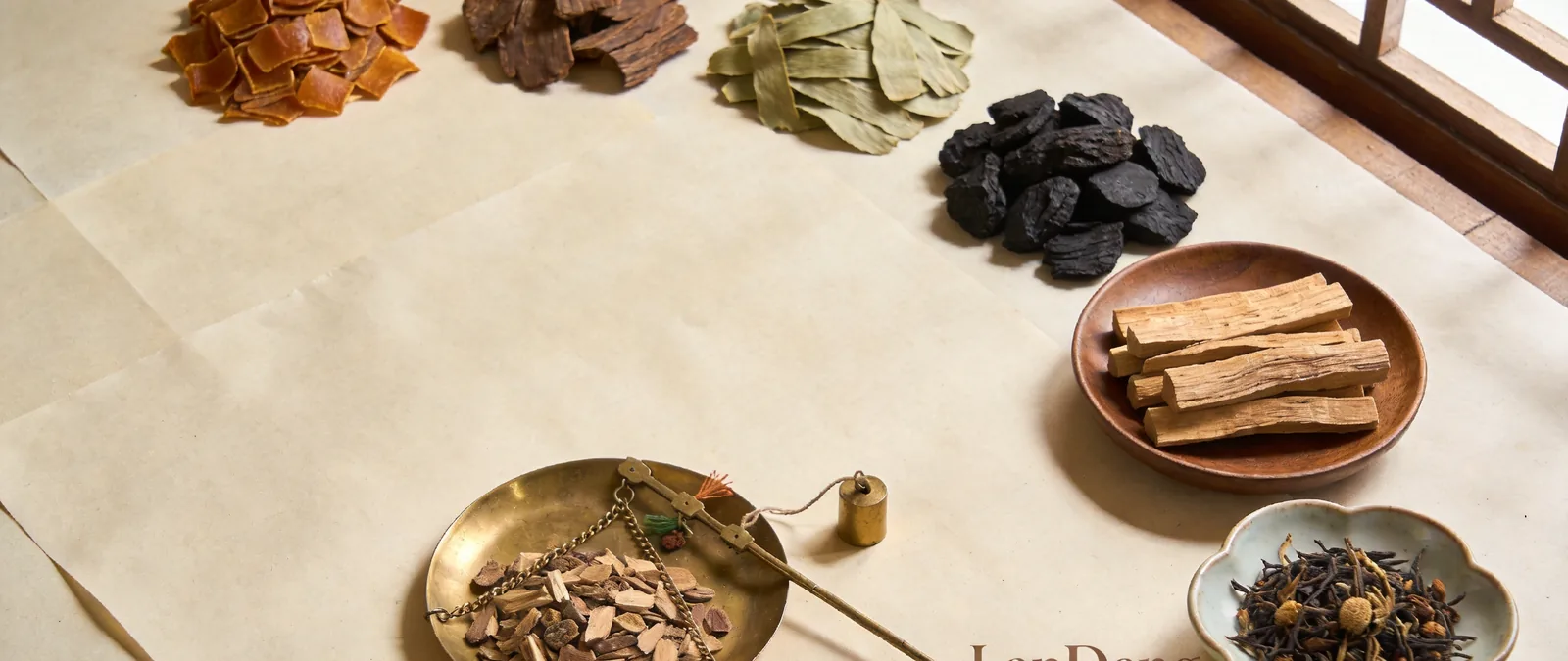Wide still life of Chinese incense ingredients on rice paper